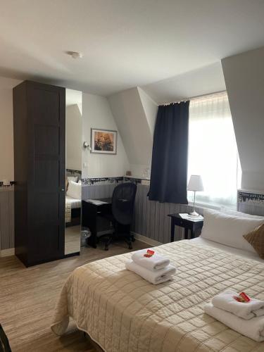 a bedroom with a bed with two towels on it at Hotel Corsten in Heinsberg