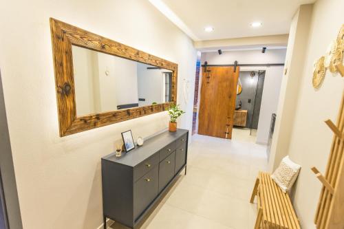 a bathroom with a dresser and a mirror on the wall at Old Town Living Apartments in Český Krumlov