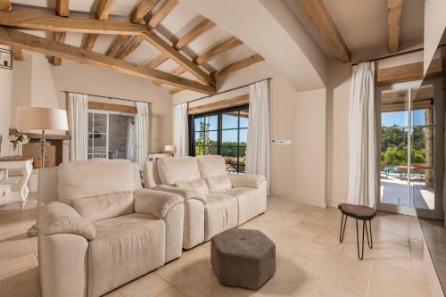 a living room with a couch and a table at Villa Plava with Panoramic Seaview and big pool in Bale