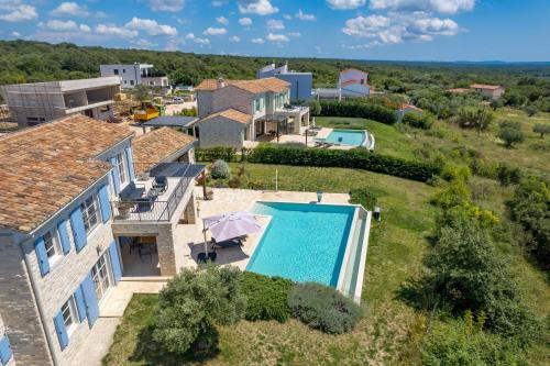 an aerial view of a villa with a swimming pool at Villa Plava with Panoramic Seaview and big pool in Bale