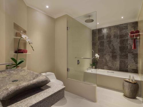 a bathroom with a shower and a sink and a toilet at Blu-Zea Resort by Double-Six in Seminyak