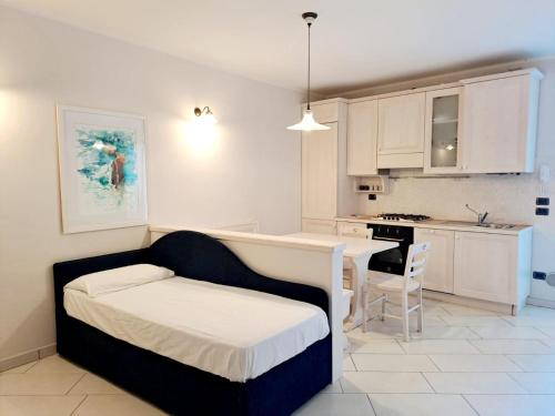 a small bedroom with a bed and a kitchen at Borgo alla Sorgente in Vallio Terme