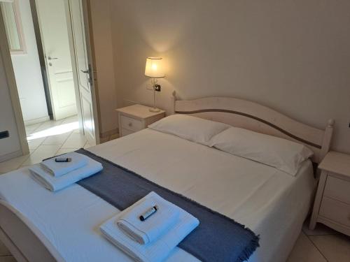 a bedroom with a white bed with two towels on it at Borgo alla Sorgente in Vallio Terme