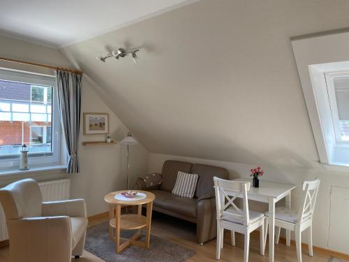 a living room with a couch and a table at MS Störtebecker, Sandwall in Wyk auf Föhr