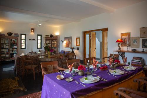 a table with a purple table cloth on it at Isla's Ridge - A CGH Earth SAHA Experience in Kodaikānāl