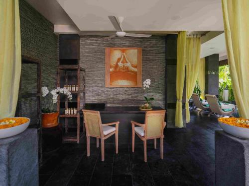a dining room with a table and chairs at Blu-Zea Resort by Double-Six in Seminyak
