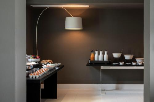a room with a table with food and a lamp at ANEMI Folegandros in Karavostasi