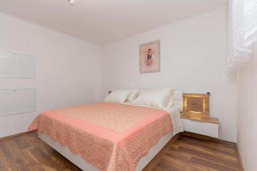 a white bedroom with a bed and a fireplace at Villa GRACO in Imotski