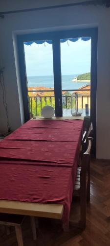 a bedroom with a bed with a view of the ocean at Adriatic View in Pješčana Uvala 