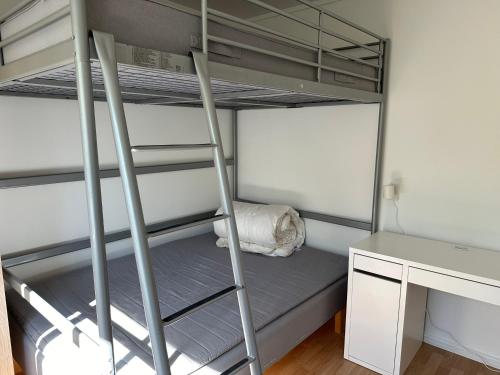 a bedroom with a bunk bed and a desk at Mandal Apartment mit Möglichkeit ein Boot zu benutzen und Angeln in Mandal