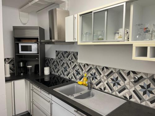 a kitchen with a sink and a microwave at Adriatic View in Pješčana Uvala 