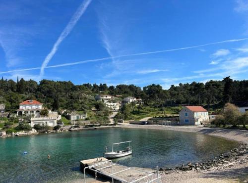 a boat is docked at a dock in the water at Holiday Home Aldo in Rogač