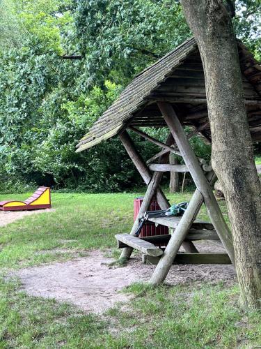 a picnic table under a tree in a park at Zum ehemaligen Kaffeekännchen in Funfseen