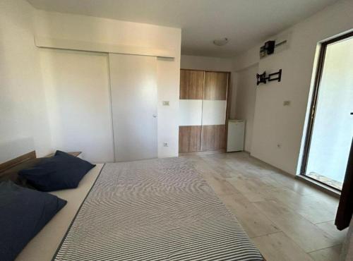 a bedroom with a large bed in a room at Holiday Home Aldo in Rogač