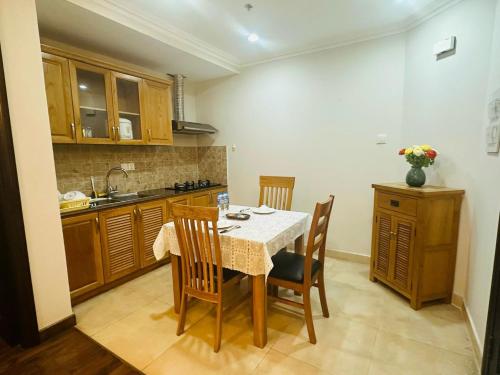 a kitchen with a table and chairs and a sink at Felix Alley in Ho Chi Minh City