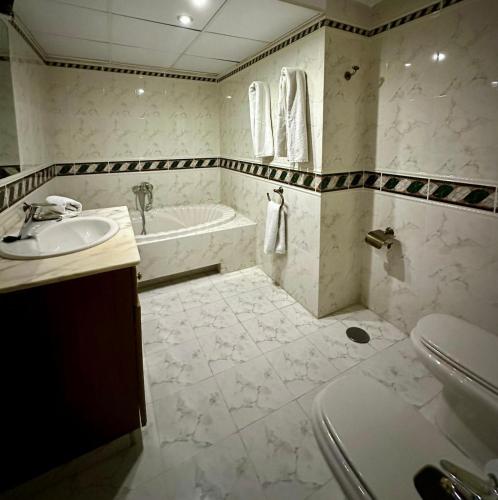a bathroom with a tub and a sink at Carmen Home in Córdoba