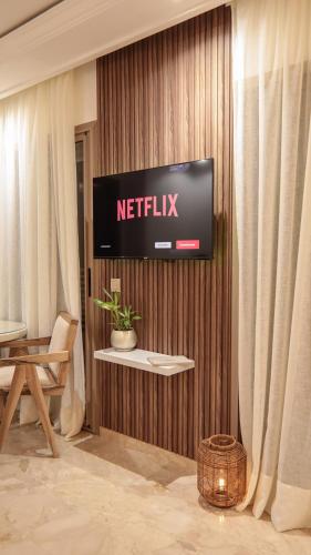a television on the wall of a hotel room at Piscine chauffée - Sauna - Hammam - Appart Coeur de Gueliz in Marrakech