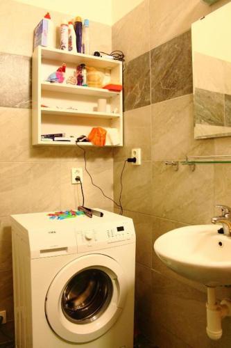 a bathroom with a washing machine and a sink at ADC Design Apartmány in Brno