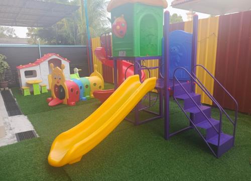a childrens playground with a slide and a slideintend at Hana Homestay Kolam Terengganu in Marang