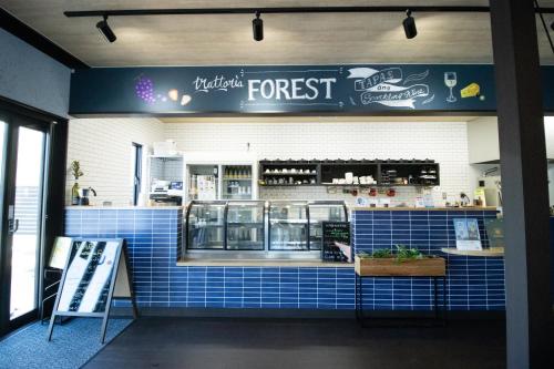 a fast food restaurant with a blue tile wall at YUKARA Glamping 北海道大沼公園 in Ōnuma
