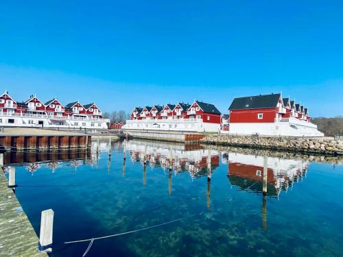 a group of red and white buildings on the water at Luxury Holiday Home With Sea View in Gråsten