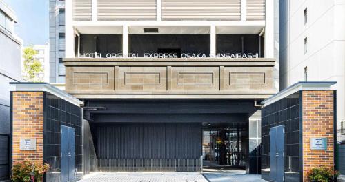 an entrance to a building with a garage at Hotel Oriental Express Osaka Shinsaibashi in Osaka