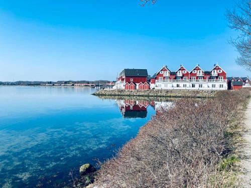 a row of red houses on a island in the water at Luxury Holiday Home With Sea View in Gråsten