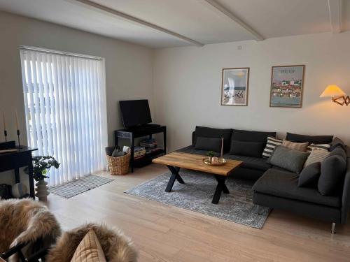 a living room with a couch and a coffee table at Luxury Holiday Home With Sea View in Gråsten