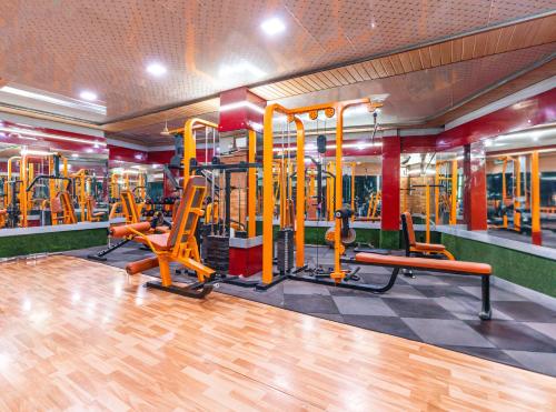 a gym with orange gym equipment in a building at Treebo Westview in Vapi