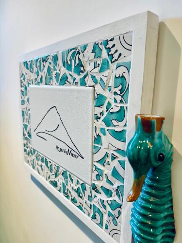 a picture of a blue vase next to a card at Vesuvio View in Vico Equense