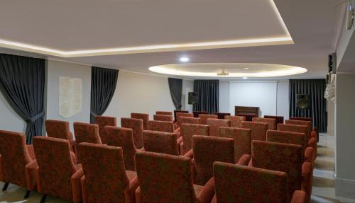 a conference room with red chairs and a ceiling at Antique Roman Palace Museum Hotel - Adults Only Ultra All Inclusive in Alanya