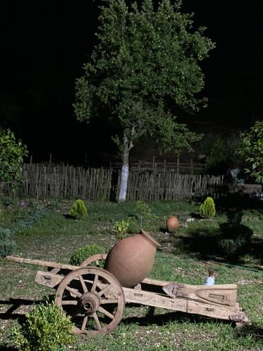 a wooden cart with a vase sitting on top of it at Kirta in Gordi