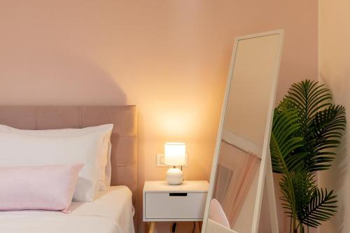 a bedroom with a bed and a mirror and a lamp at The View in Vela Luka
