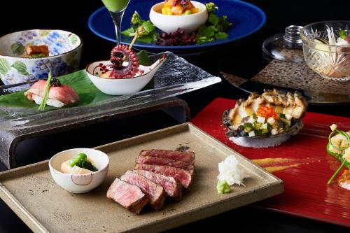 a table with plates of food and bowls of food at hotel kanra kyoto in Kyoto