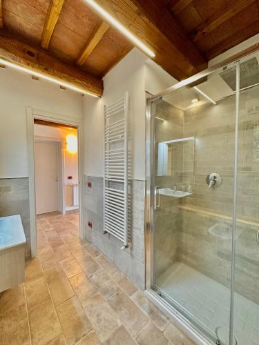 a bathroom with a shower and a glass shower stall at Panorama-Ferien-Toscana Your cozy and fully equipped vacation home in Massa Marittima