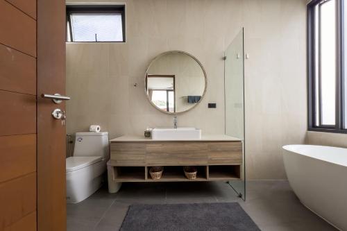 a bathroom with a sink and a mirror and a toilet at Stephanie villa by fisherman Village in Nathon Bay