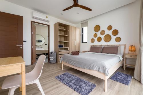 a bedroom with a bed and a table and a desk at Stephanie villa by fisherman Village in Nathon Bay