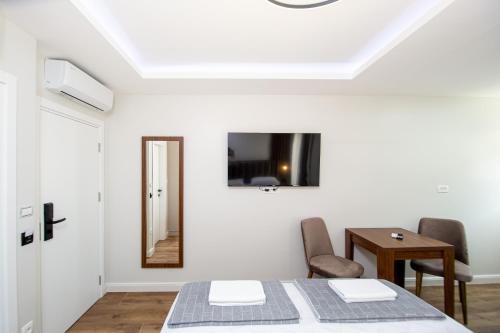 a dining room with a table and a mirror at Apartment Sofija in Budva