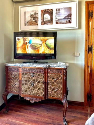 a flat screen tv sitting on top of a dresser at Almunia de San Miguel in Toledo