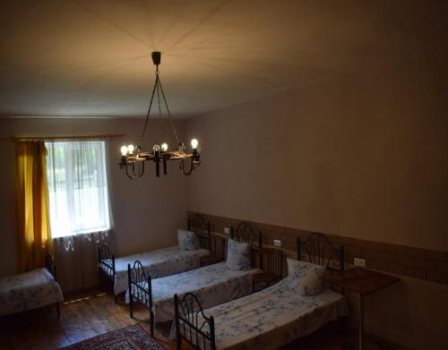 a dining room with tables and chairs and a chandelier at BenSon Adventures Resort in Gomkʼ