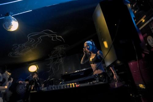a woman with blue hair standing in a room at Cafe Moto Hostel in Puerto Princesa City
