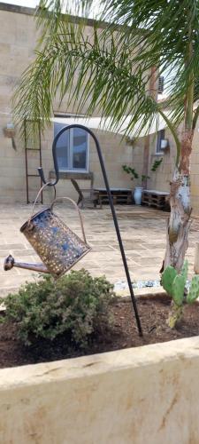 a chair sitting next to a tree in a yard at Masseria Petra in Martano