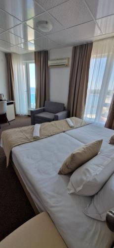 a large white bed in a hotel room at Elite Family Hotel in Kiten