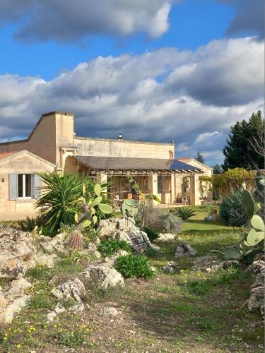 a house with a garden in front of it at Masseria Petra in Martano