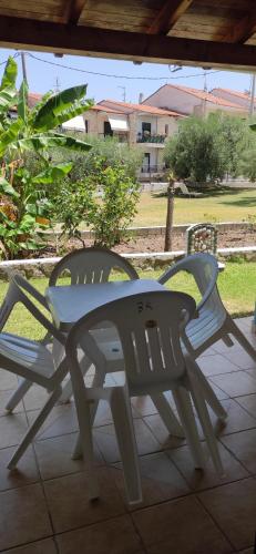 a plastic bench sitting on a patio at Kiparissis Apartments in Kriopigi