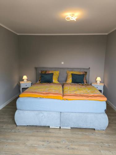 a large bed in a room with two night stands at Ferienwohnung Sonnenschein in Ostseebad Sellin