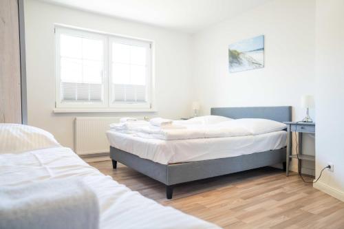 Ένα ή περισσότερα κρεβάτια σε δωμάτιο στο Windflüchter - Bucht