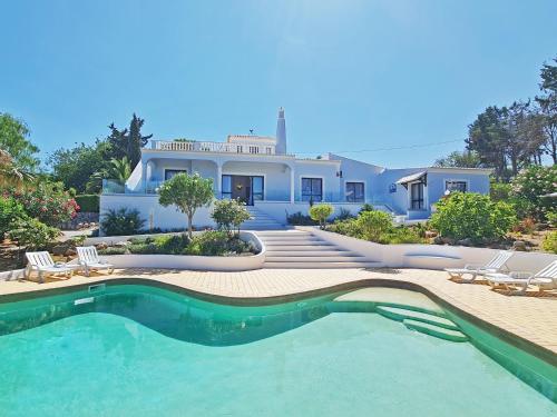 a house with a swimming pool in front of a house at Casa Vitória - with private pool in Pêra