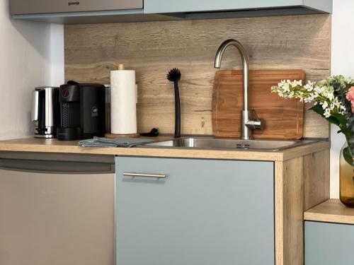 a kitchen counter with a sink and a microwave at Apartments Salzburg - Bergstraße in Salzburg