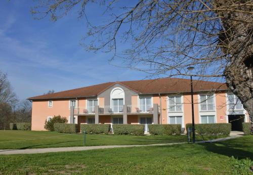 a large pink building with a brown roof at Best Western Golf d'Albon in Albon